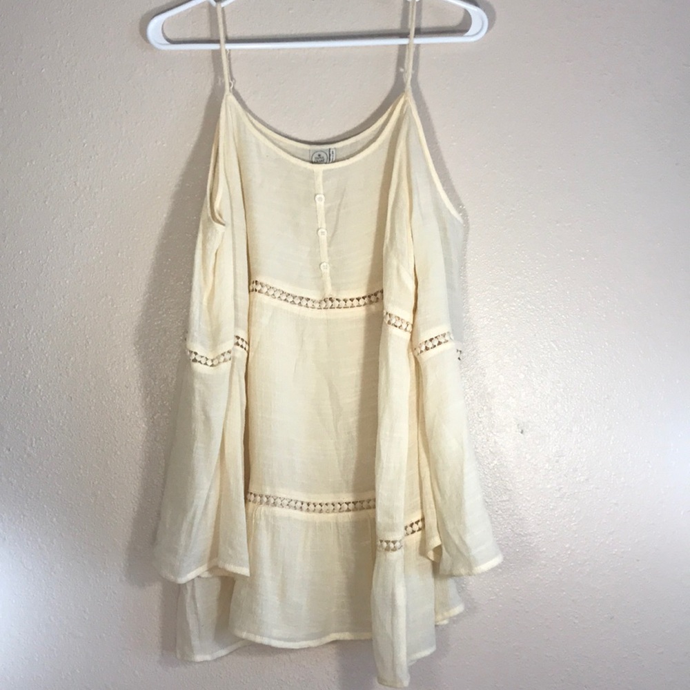 Cream colored flowing blouse, off the shoulder